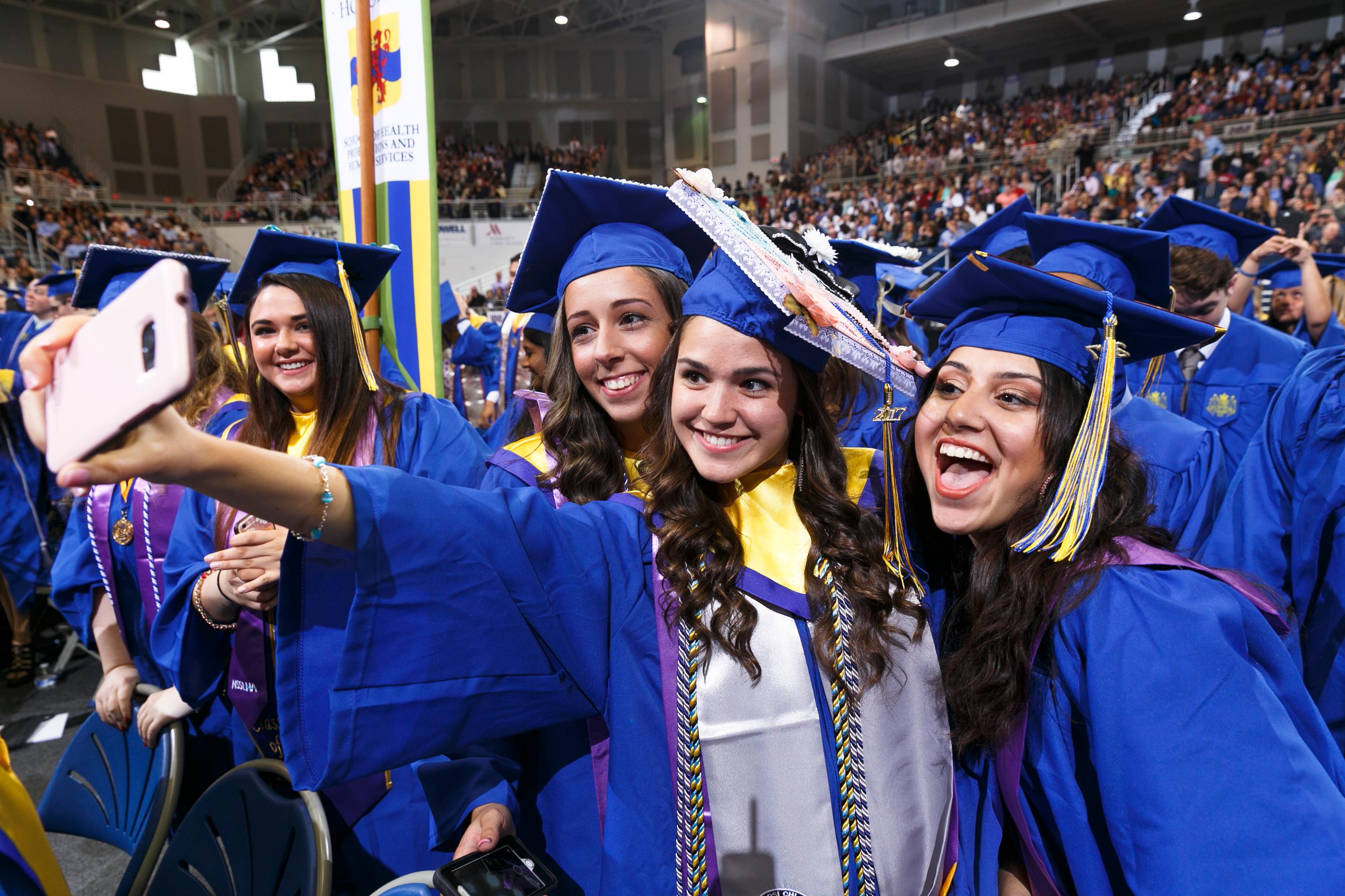 Hofstra group of female students taking a photo of themselves with their caps and gowns on graduation 2017_36525.jpg